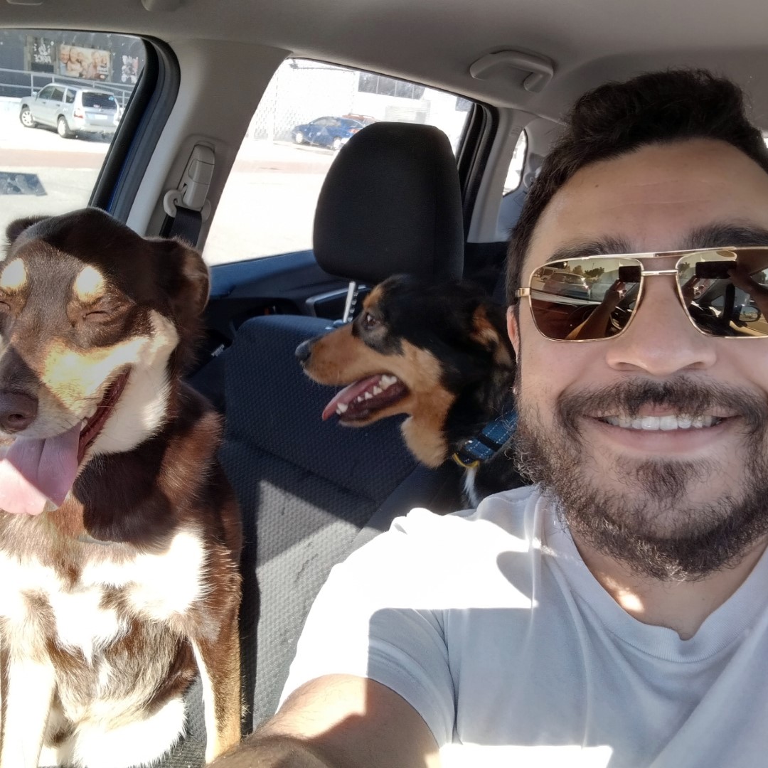 Selfie of Paul with his two doggos in the car