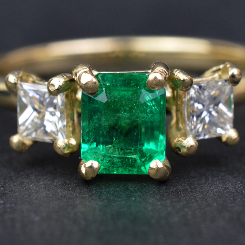 Close up of the Emerald and Diamond gold engagement ring